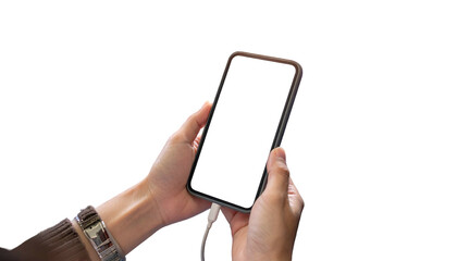 Human hands holding phone with blank screen, charging cable connected, isolated on black