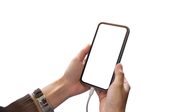 Human hands holding phone with blank screen, charging cable connected, isolated on black