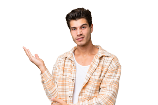 Young handsome caucasian man over isolated background having doubts