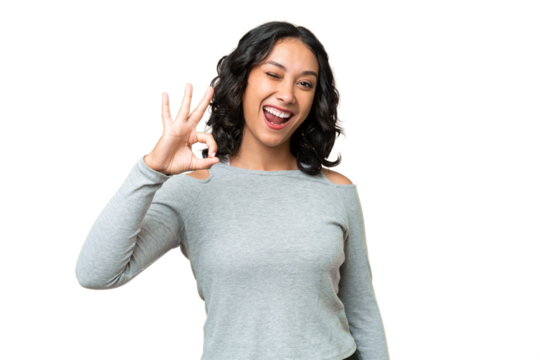Young Argentinian woman over isolated background showing ok sign with fingers
