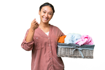 Young Uruguayan woman holding a clothes basket over isolated chroma key background shaking hands for closing a good deal
