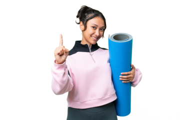 Young sport woman going to yoga classes while holding a mat over isolated chroma key background showing and lifting a finger