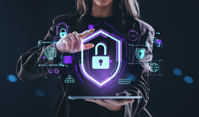 Woman interacting with holographic cybersecurity lock and shield concept interface on digital tablet in futuristic environment background.
