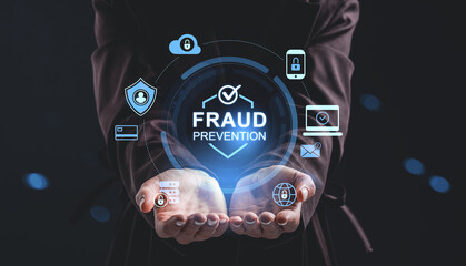 Fraud prevention technology concept with hologram security icons above open hands on dark background showing digital protection system interface.