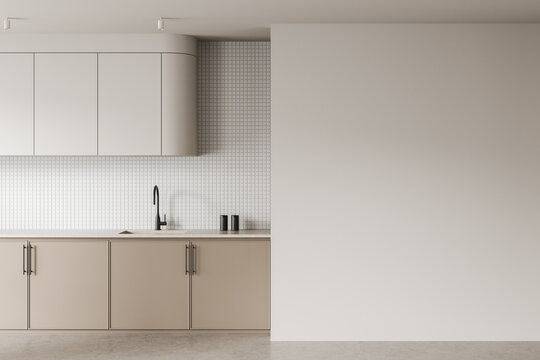 Modern kitchen interior with blank wall space and minimalist cabinetry for design or poster mockup template in neutral colors and clean architecture style. 3D Rendering