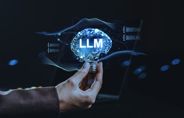Human hand holding a lightbulb with glowing digital brain labeled LLM representing large language model and AI tech concept on dark background..