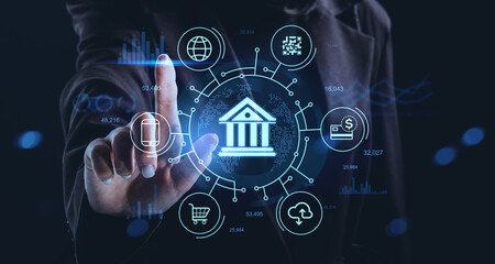 Futuristic banking technology concept with digital hologram interface featuring financial icons and a person interacting through a virtual touchscreen panel.