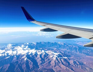 Obraz premium Airplane Wing Over Majestic Mountain Range