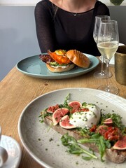 Bruch with a breakfast burger and delicious burrata on sourdough bread with figs, celebrating with some champagne