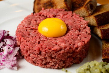 Beef Tartare Hovezi Tatarak Czech Style with Raw Egg Yolk, Topinki Toasted Bread Red Onion and Gherkin