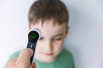 Infrared Thermometer Measuring Childs Temperature Medical Check Concept