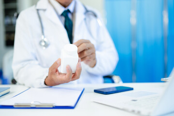 Fototapeta premium Medical technology concept. Doctor working with mobile phone and stethoscope in modern office
