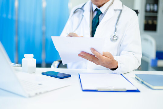 Medical technology concept. Doctor working with mobile phone and stethoscope in modern office