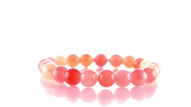 A bracelet is being spinning. Photography studio, light. Natural stone jewelry. 