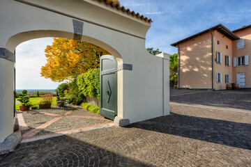 The entrance to a magnificent garden overlooking the Friulian plain on a sunny autumn day. Santa Margherita del Gruagno main square, Udine province, Friulia Venezia Giulia, Italy.