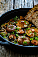 Fried saffron milk cap mushrooms on wooden table