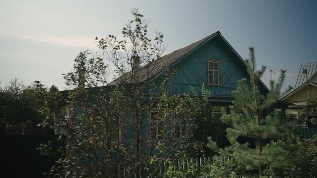 View of a classic Russian village hut in summer at dawn. Dolly camera