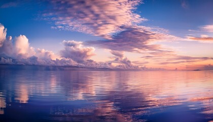 Fototapeta premium Dreamy purple sunset sky with delicate cirrus clouds over the calm sea 
