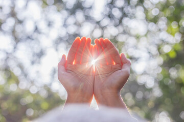 Human hands respect and pray on nature bokeh background