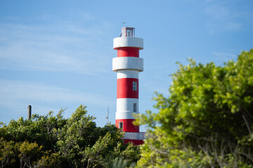 Red and white lighthouse in El Cuyo, a fishing village in Yucatan, Mexico.