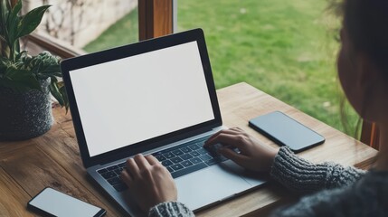 Woman Working on Laptop at Home with Blank Screen Near Window in Cozy Setting