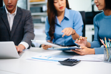 Fototapeta premium Business people meeting at office writing notes about sticky notes Laptop,tablet Planning and Brainstorming Strategies of Colleagues in office.