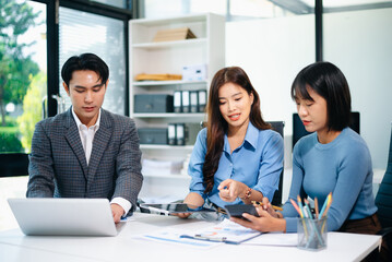 Asian business professionals discussing strategy and teamwork in office, showing leadership, success, and collaboration concepts.