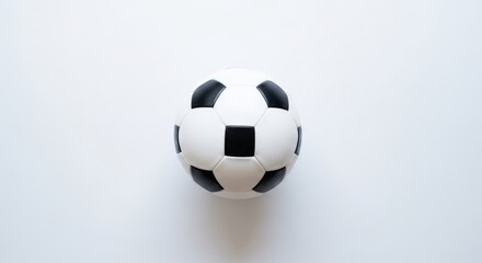 Obraz premium Classic black and white soccer ball on a clean, light background. A symbol of the world's most popular sport.