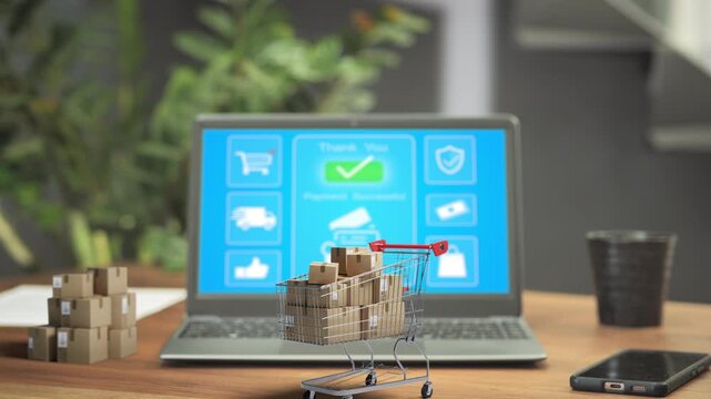 3d Shopping cart full of purchasing boxes on the desk in front of laptop computer,ecommerce internet selling,e-commerce purchasing online concept
