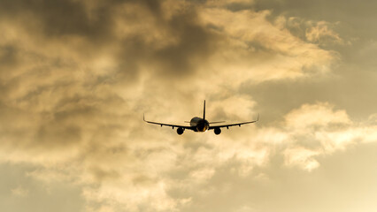 Passenger plane taking off during sunset