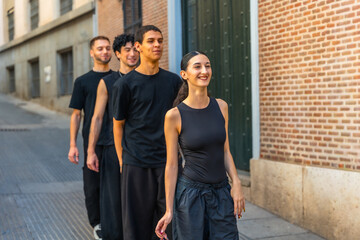 Group of young dancers walking smiling on street