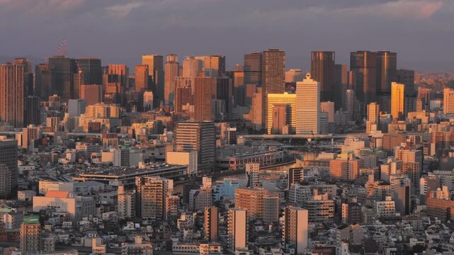 establishing shot of osaka skyline modern business district of umeda seen from distance at sunset dusk