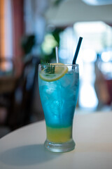 Blue lemonade served in a glass with lemon