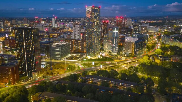 Aerial hyperlapse gliding over Mancunian Way, revealing Manchester&rsquo;s skyline and modern towers glowing at blue hour.