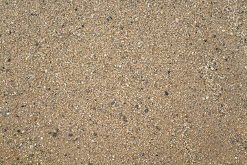Coarse sand surface pattern in outdoor environmental. Background and textured photo.