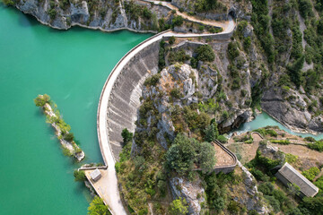 Aerial view of Pena Dam and Reservoir on sunny summer day. Santa Maria de la Pena, Huesca, Spain.