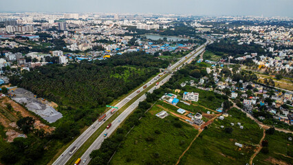Arial shot of Beautiful road infrastructure of karnataka in India. Aerial view city traffic Highway road with car vehicle movement in Bangalore.