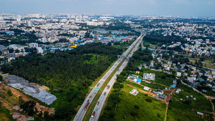 Arial shot of Beautiful road infrastructure of karnataka in India. Aerial view city traffic Highway road with car vehicle movement in Bangalore.