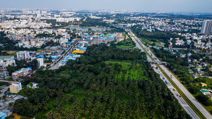 Arial shot of Beautiful road infrastructure of karnataka in India. Aerial view city traffic Highway road with car vehicle movement in Bangalore.