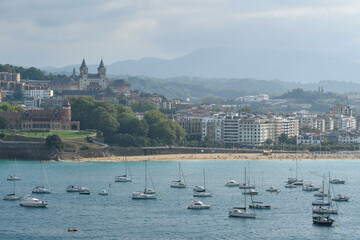 View of San Sebastian (Donostia), La Concha Beach and boats in La Concha Bay. Basque Country, Spain.