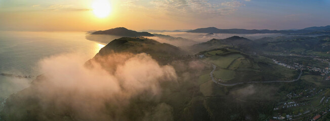 Panoramic sunrise aerial view of clouds above Zarautz town. Basque Country, Spain.