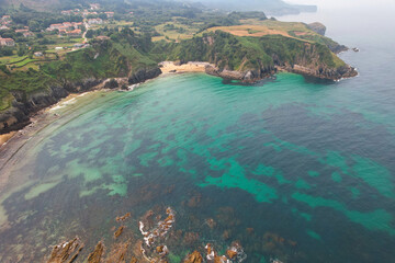 Aerial view of Arama Beach (Playa de Arama) on sunny summer day. Pechon, Cantabria, Spain.