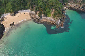 Bird's eye view of Arama Beach on sunny summer day. Pechon, Cantabria, Spain.