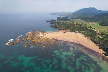 Drone view of Amio Beach on sunny summer day. Pechon, Spain.