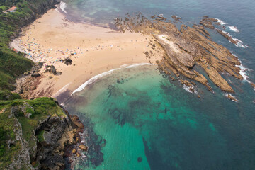 Aerial view of Amio Beach on sunny summer day. Pechon, Cantabria, Spain.
