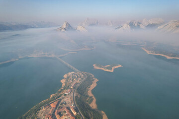 Aerial view of Riaño reservoir and mountains under the smoke from forest fires. Montaña de Riaño and Mampodre Regional Park, Castile and Leon, Spain.