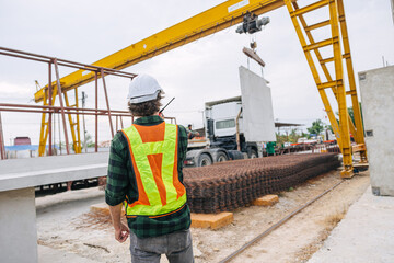 Professional engineer male working in concrete precast plant factory control operate lifting crane...