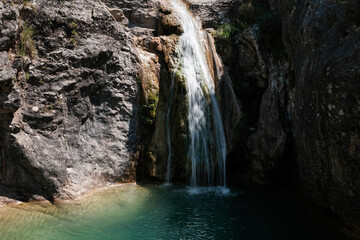 Long exposure shot of La Gorguina waterfall in Gorg Gorge on sunny summer day. La Febró, Tarragona, Spain.