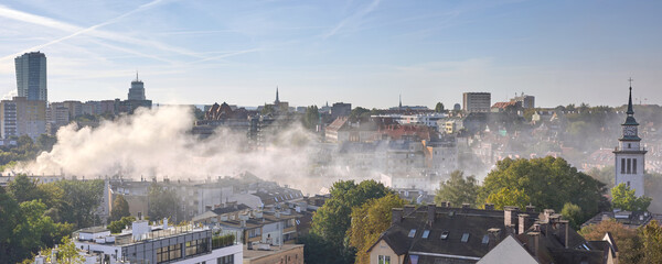 Smoke from the chimneys of coal heated houses. © MaciejBledowski