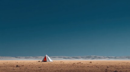 A lone white tent with orange interior sits in a vast, arid landscape under a clear blue sky
